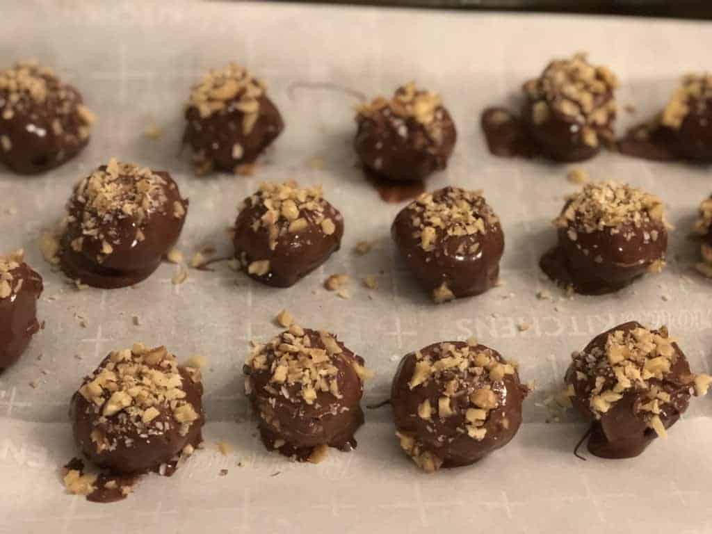 Easy to make peanut butter balls for a make ahead dinner party set on a tray.
