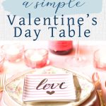 A simple pink-themed table set or Valentine's Day with old china, a "love" plate on top, simple votives in pink glass, and wine glasses.